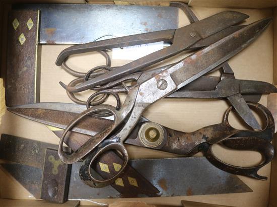 A collection of steel scissors and brass inlaid set squares